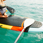 closeup-of-person-kneeling-on-a-paddleboard